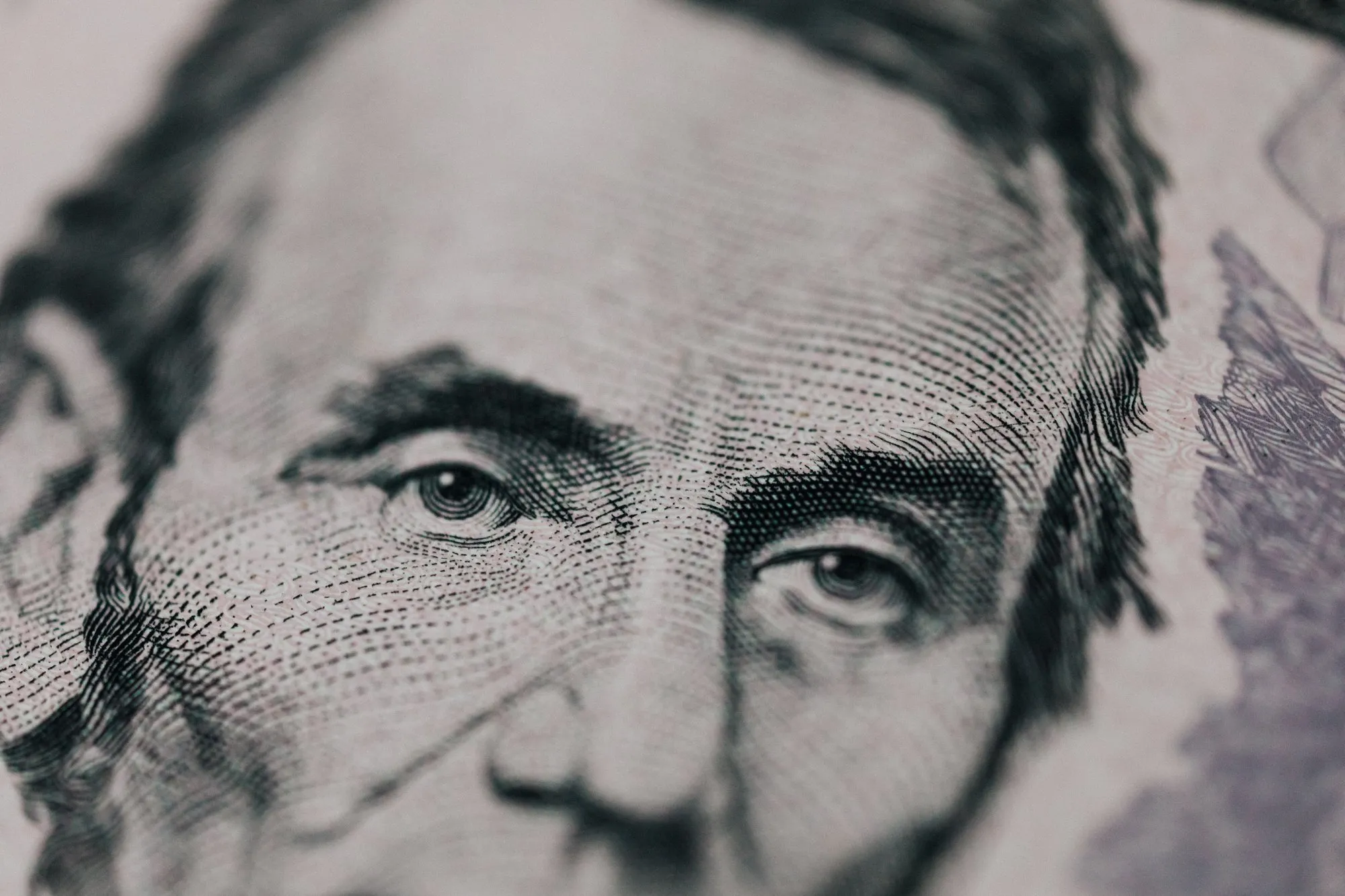 Close-up of Abraham Lincoln’s portrait on a US five-dollar bill